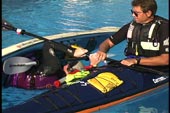 paddler using bridge to roll up between kayaks