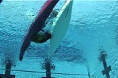 u/w view paddler rolling up close between boats