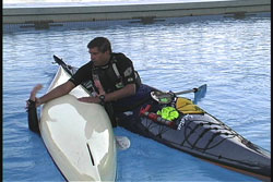 paddler still in overturned kayak