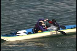 while resting on each others kayak they pump out each others kayak