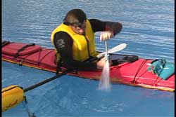 Paddler pumping out water from cockpit
