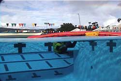 paddler getting into overturned kayak