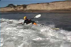 paddler getting back up in wave