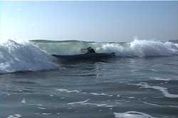 kayaker leaning into wave that is over their head